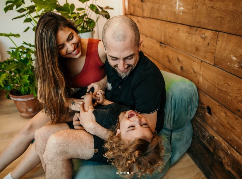 Family laughing together on the floor